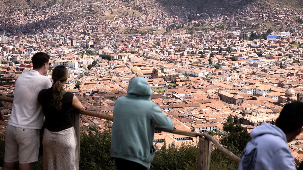 Tourists looking at buildings in Peru