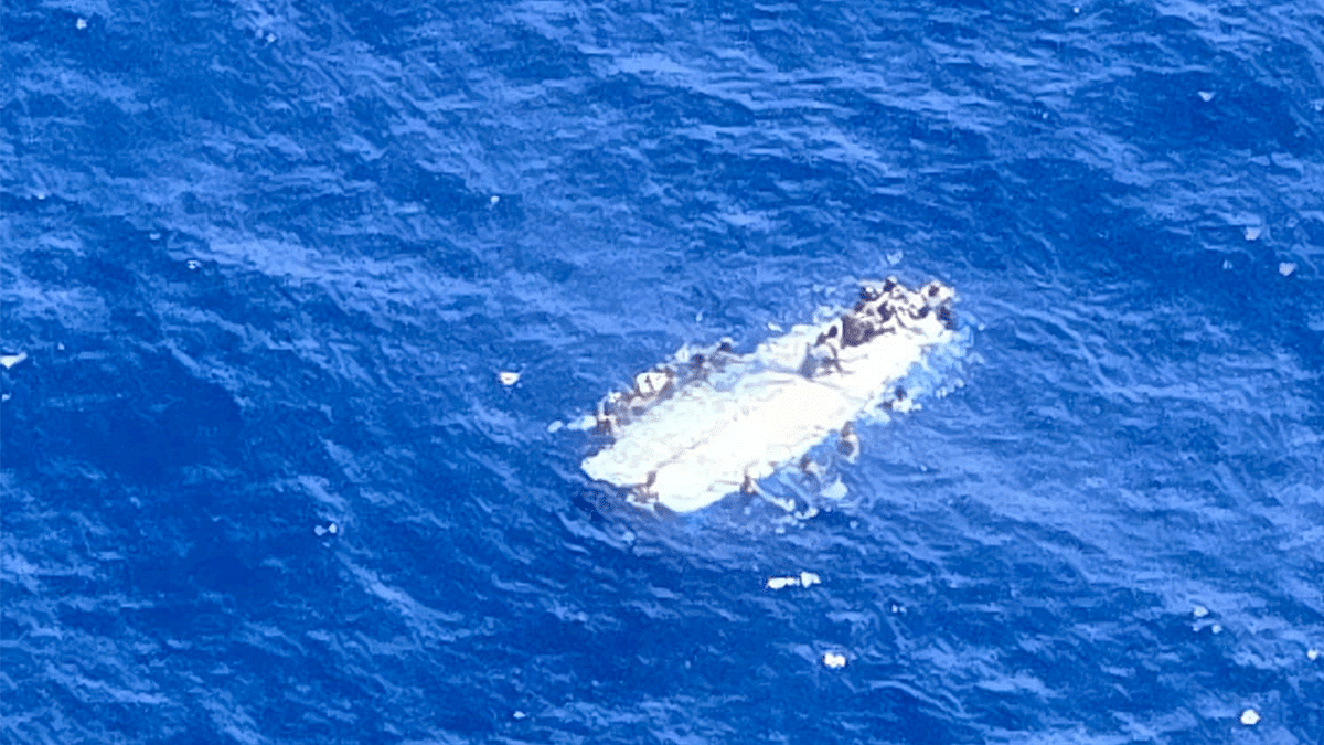 People in the water besides a capsized vessel off Mona Island