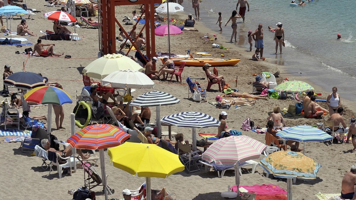 Athenians relax on the beach at Vouliagmeni during European Parliament election day.