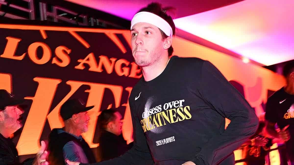 Austin Reaves #15 runs out of the tunnel before the Lakers-Thunder playoff game.