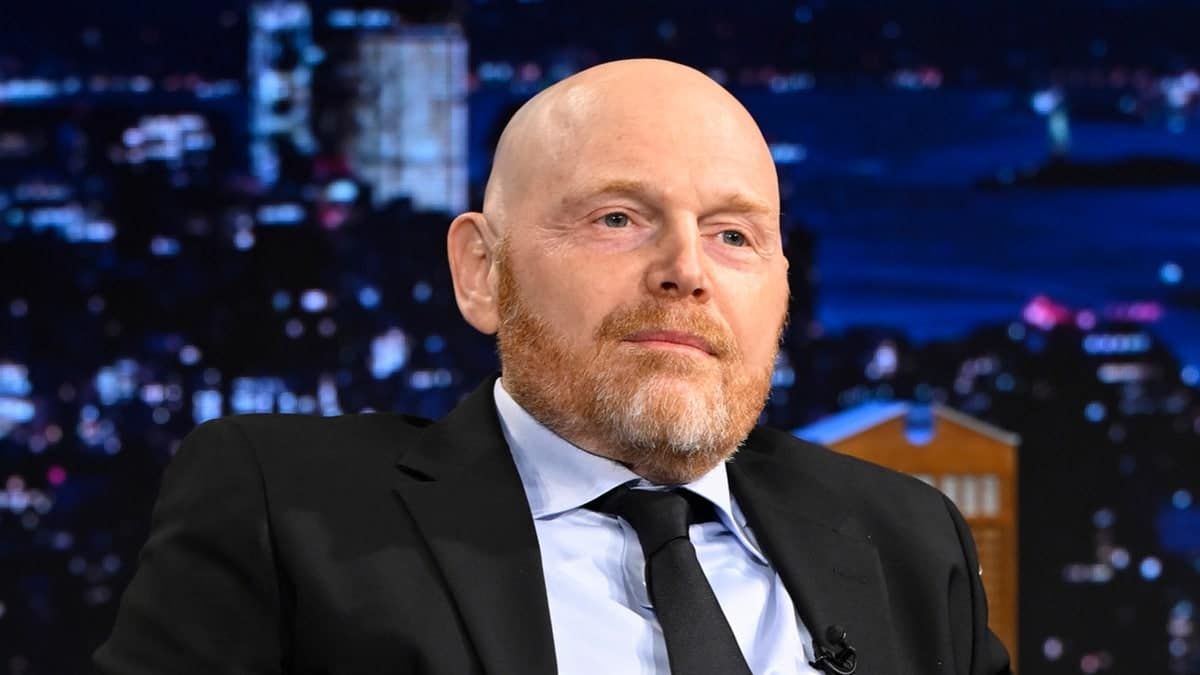 Bill Burr is seated on stage during an Episode of The Tonight Show starring Jimmy Fallon