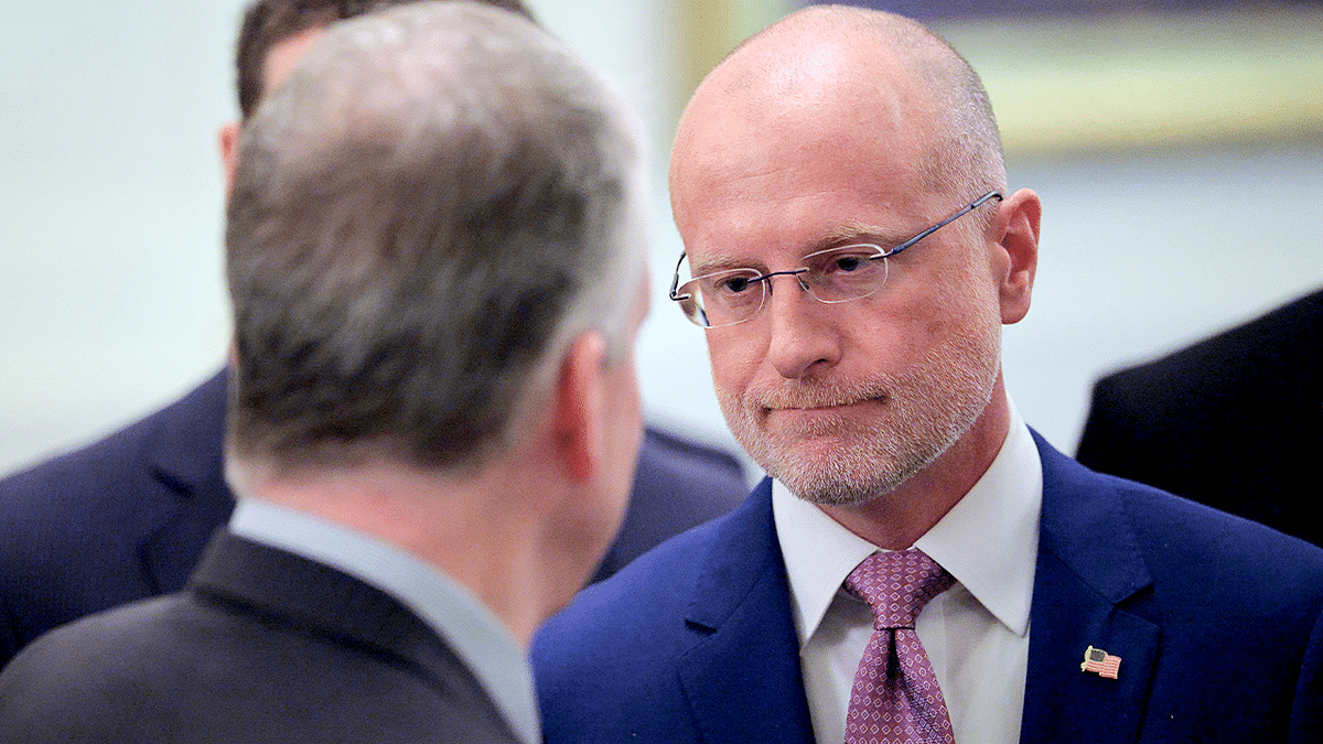 FCC Chairman Brendan Carr speaks with Sen. Dan Sullivan at White House.