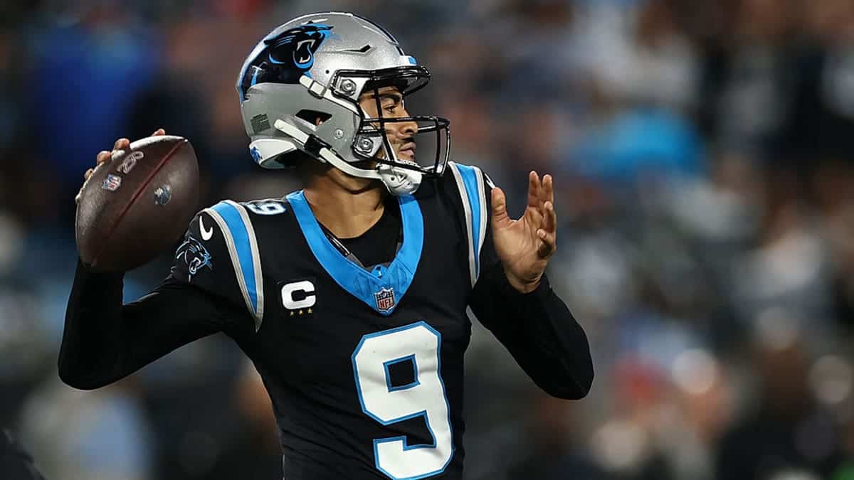 Bryce Young throwing a pass during a football game at Bank of America Stadium.