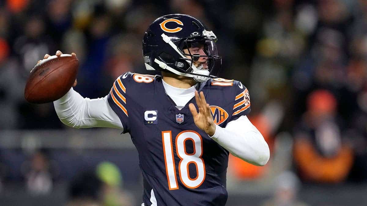 Caleb Williams throwing a pass during a football game at Soldier Field.