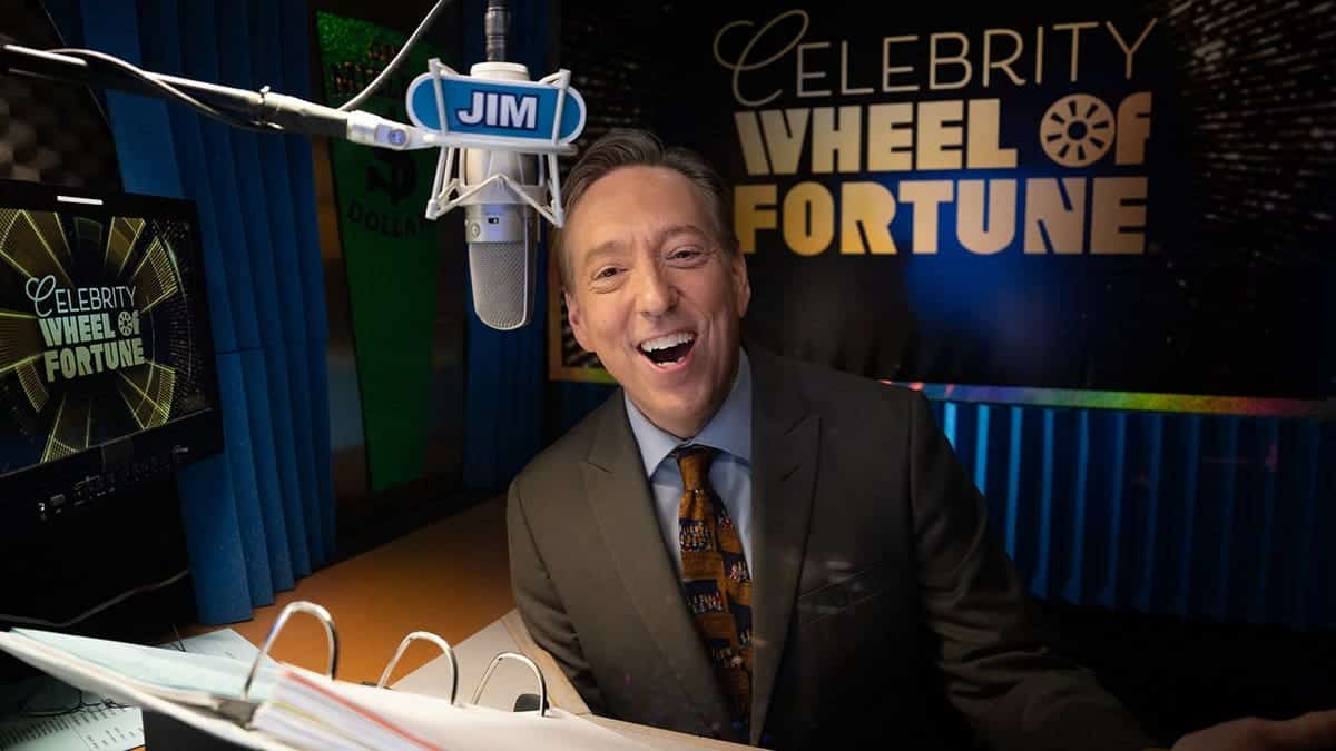 Ilana Glazer, Chelsea Peretti and Moshe Kasher stand on the Celebrity Wheel of Fortune set.
