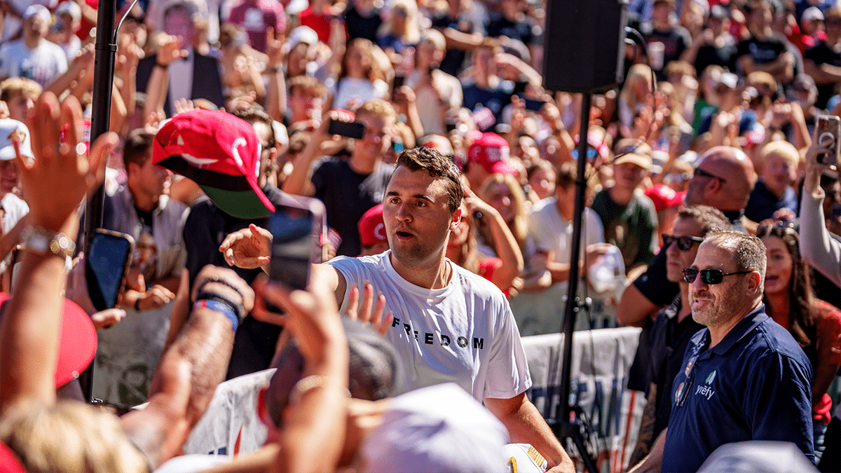 Charlie Kirk surrounded by a large audience, tosses hats to the crowd shortly before his assassination in Utah
