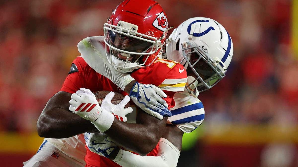 Jalen Royals of the Kansas City Chiefs is tackled by Sauce Gardner of the Indianapolis Colts.