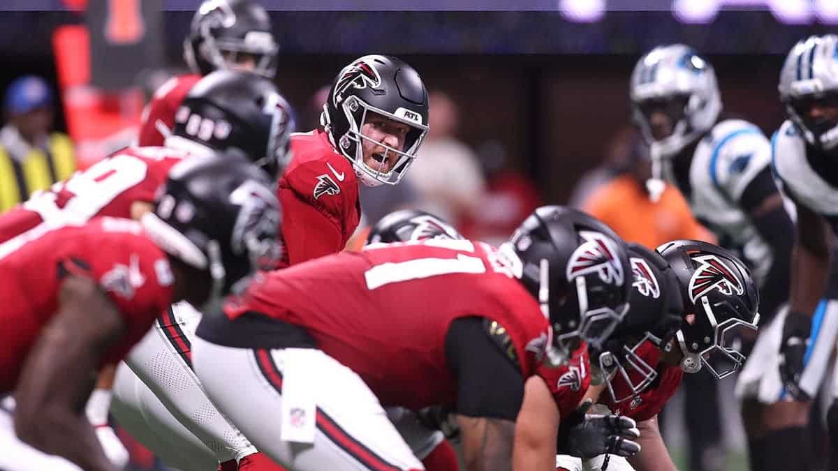Cooper Rush prepares to take a snap during the second quarter against the Carolina Panthers.