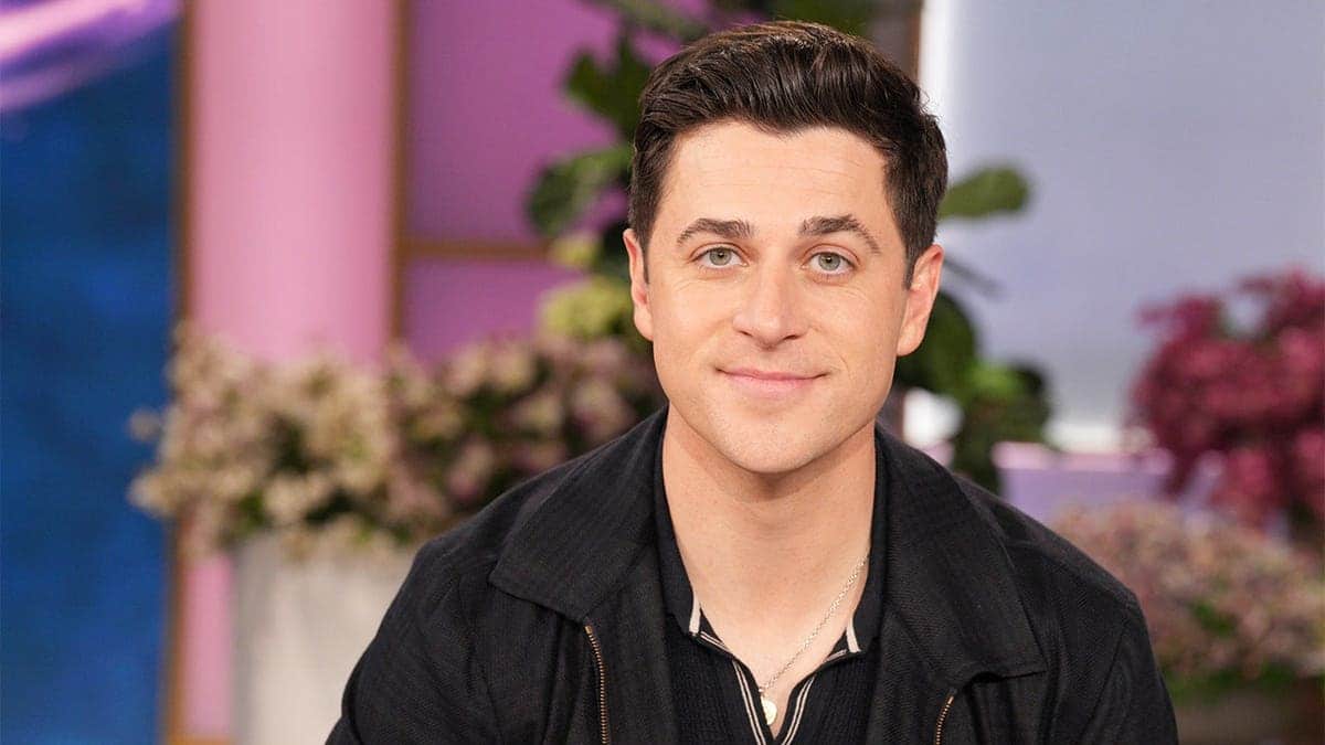 David Henrie seated on a talk show set