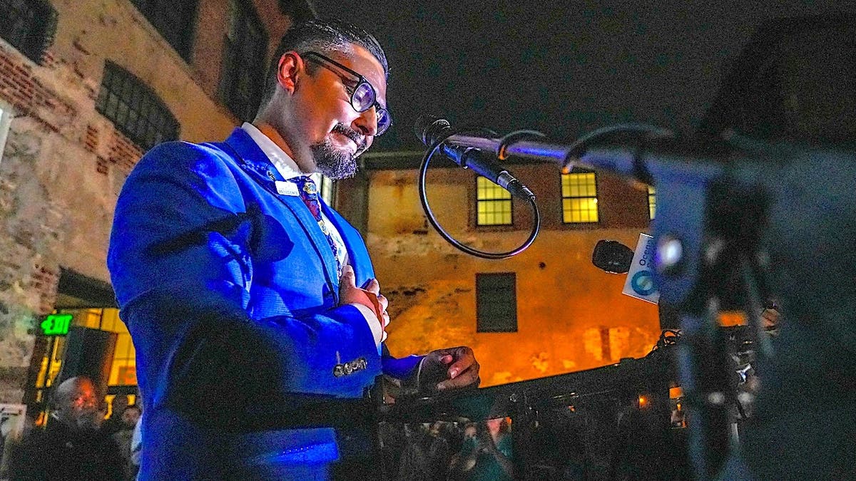 David Morales gives an acceptance speech at Riff Raff Bookstore.