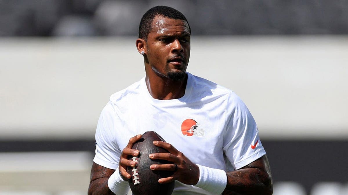 Deshaun Watson, wearing Cleveland Browns uniform number 4, warms up before an NFL game.