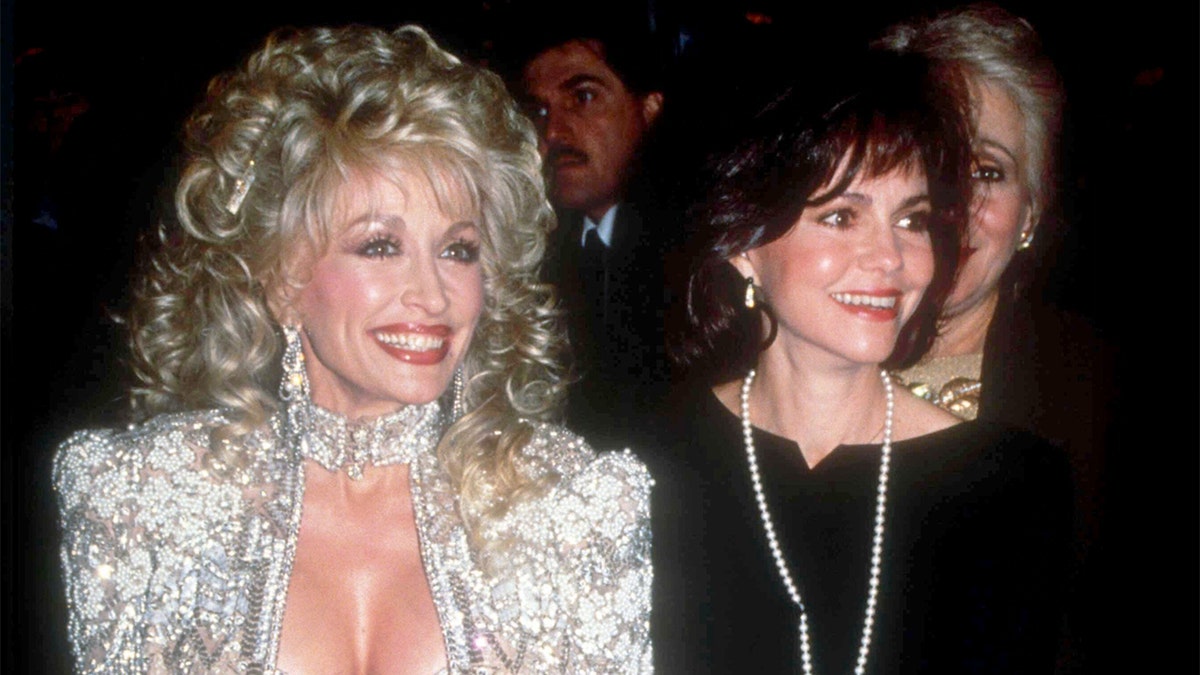 Dolly Parton smiling with Sally Field
