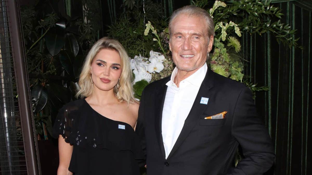Dolph Lundgren and Emma Krokdal pose for a photo at fundraiser.