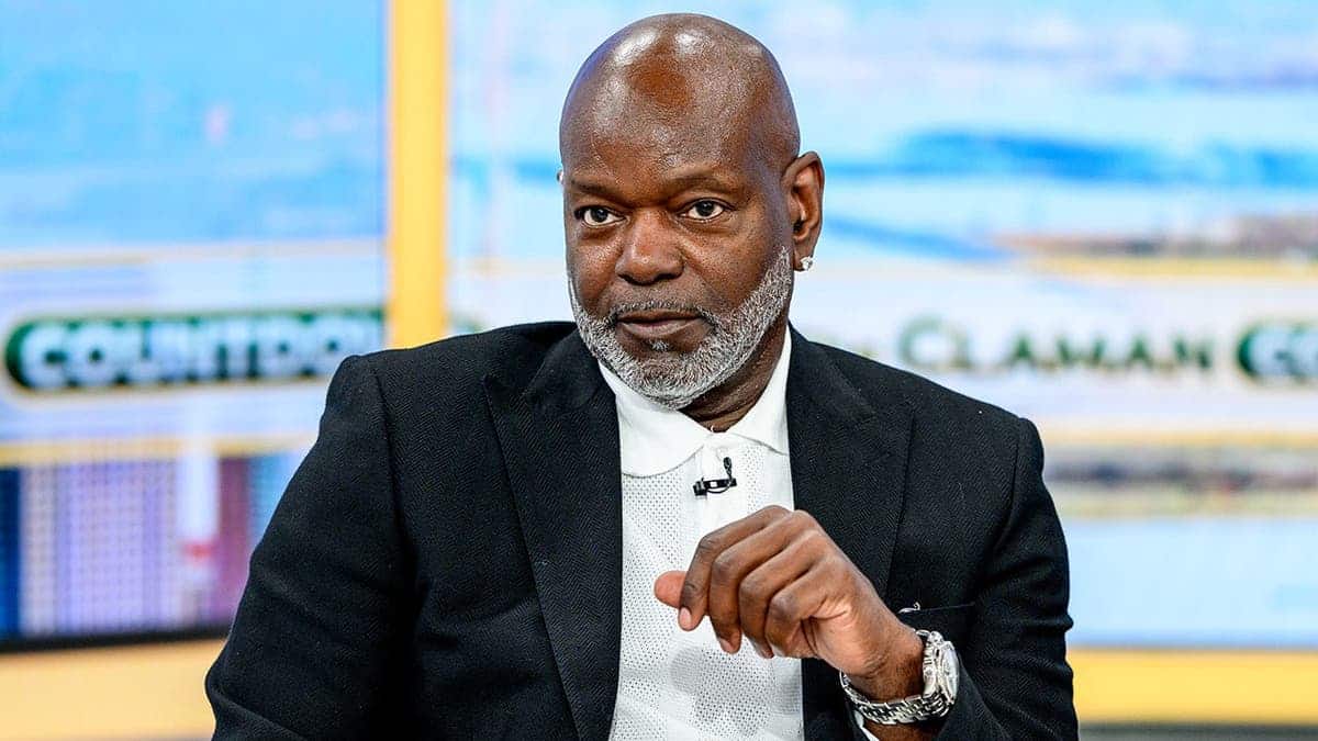 Emmitt Smith stands with Cheryl Casone in a Fox Business Network studio.