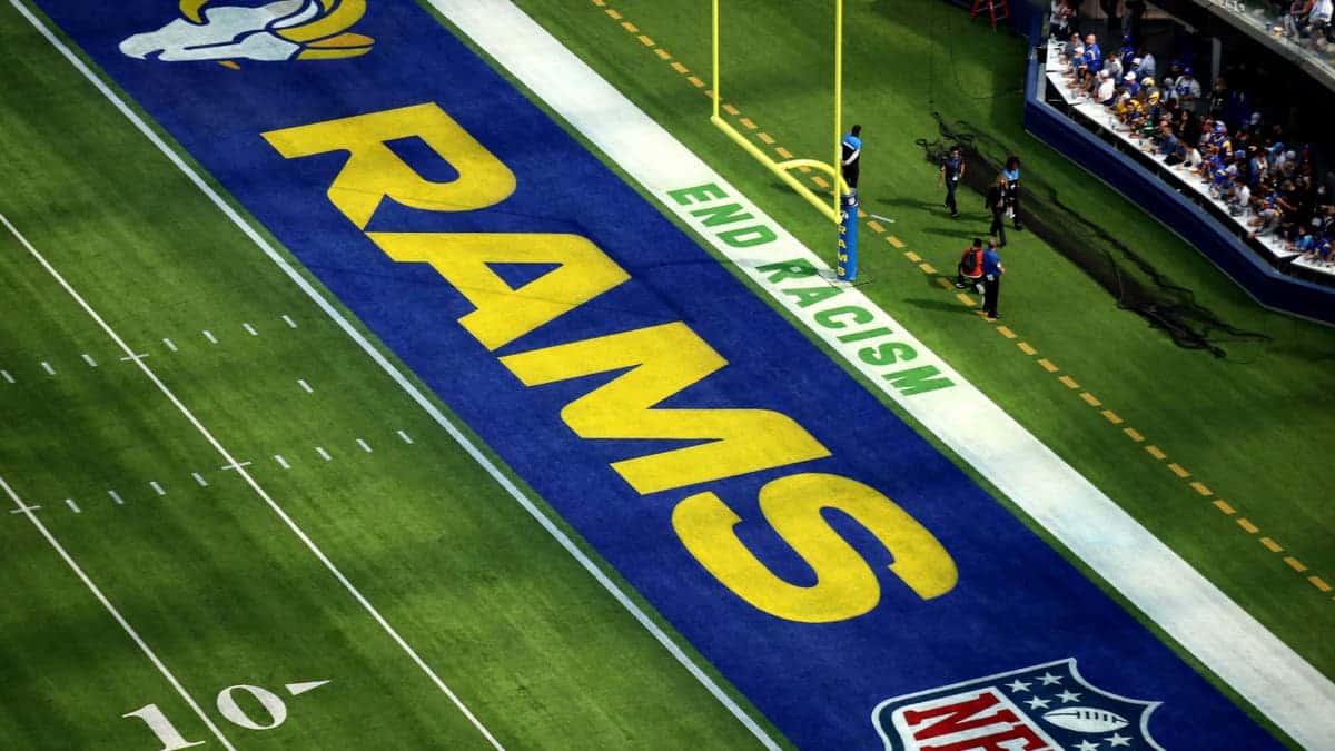 Signage reading End Racism appears in the end zone at SoFi Stadium.