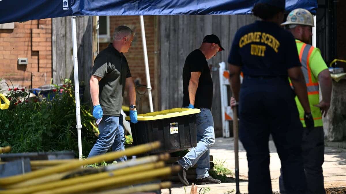 Law enforcement officers and utility crews excavate at Eugene Horsch's home in Philadelphia.
