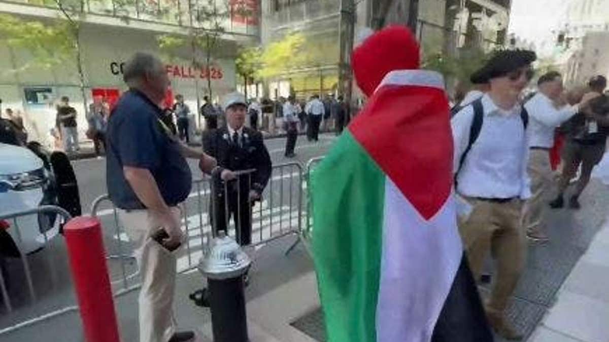 Firefighter confronting pro-Palestinian protester in Elmo costume