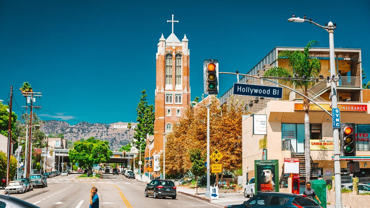 First Presbyterian Church of Hollywood stands on Hollywood Boulevard with the Hollywood Sign visible in the background.