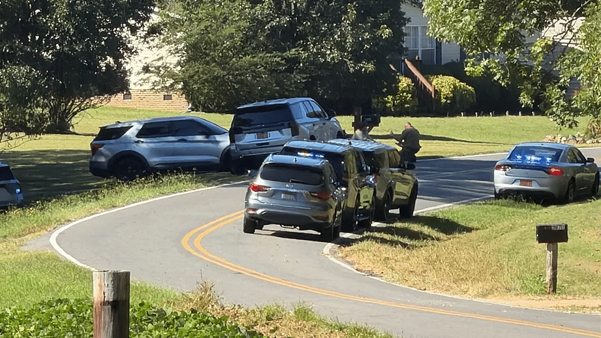Police vehicles surround the scene of a deadly shooting on Forbes Road in Gaston County