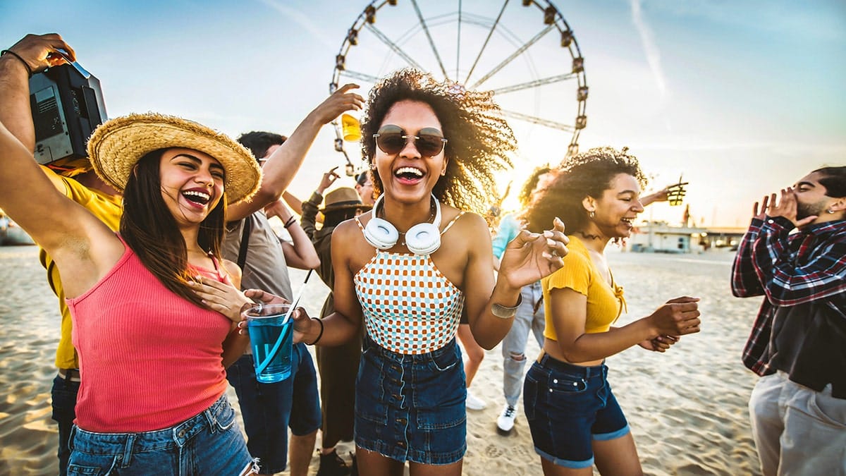 Young people partying with a ferris wheel in the background