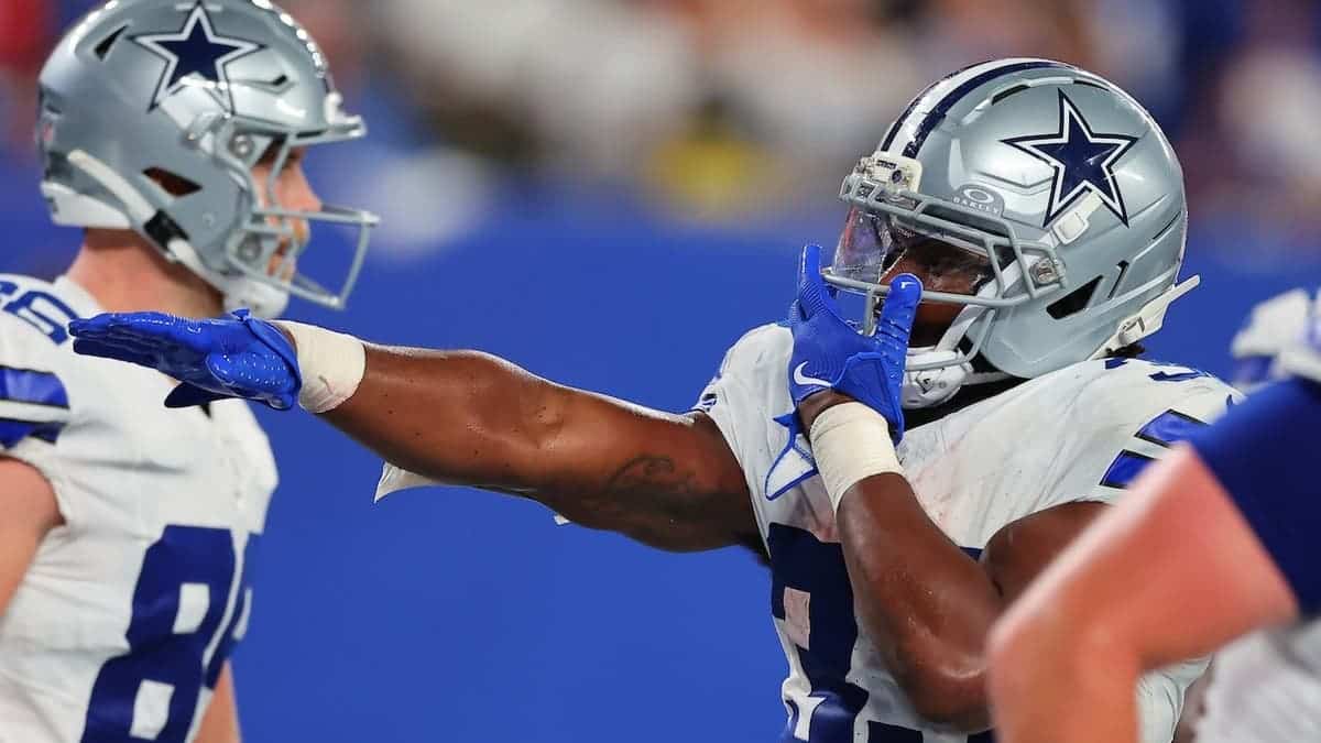 Javonte Williams #33 of the Dallas Cowboys celebrates after scoring during a game.