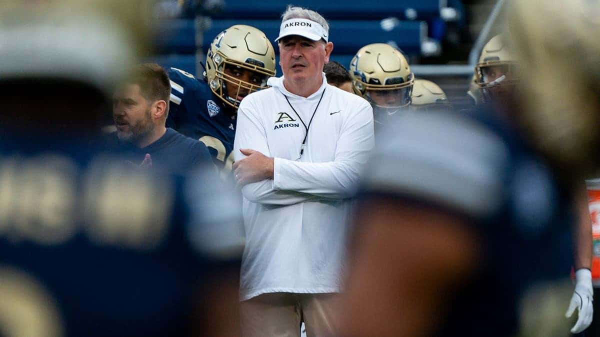 Joe Moorhead leads the Akron Zips football team through warmups.