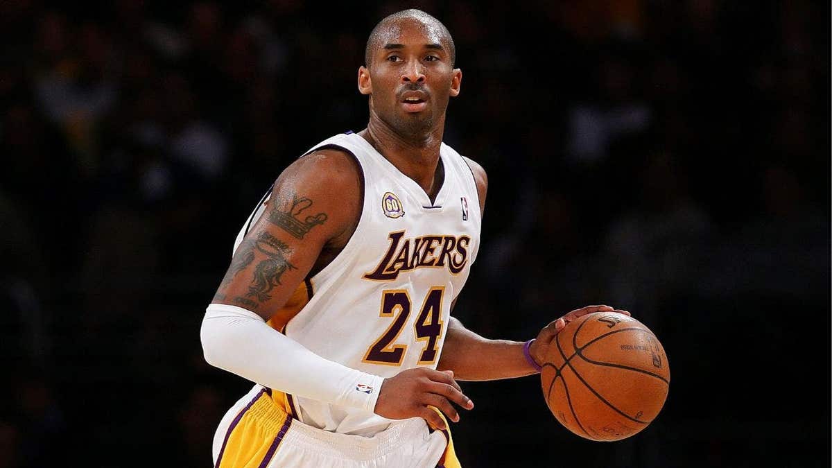 Kobe Bryant, wearing Lakers No. 24, drives the ball upcourt during a game against the Cleveland Cavaliers.