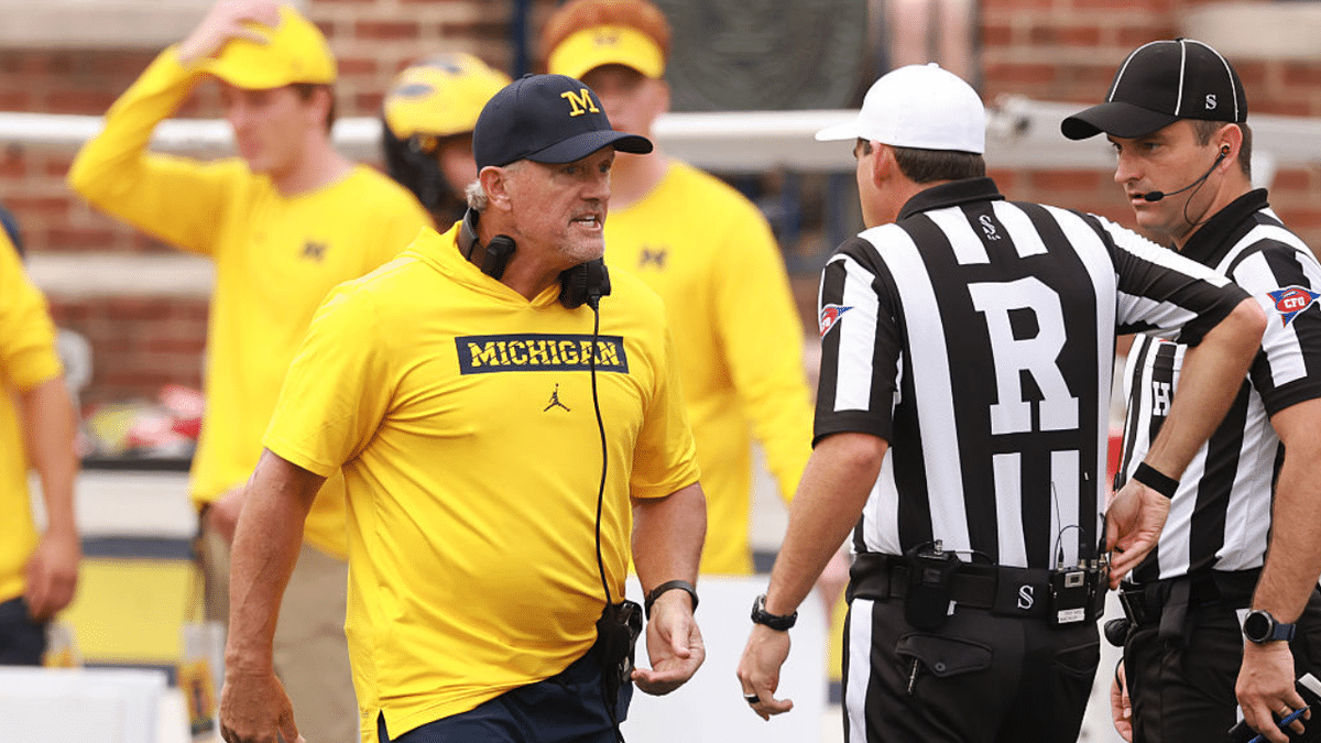 Kyle Whittingham talks with referees during Michigan Wolverines game against Oklahoma Sooners.