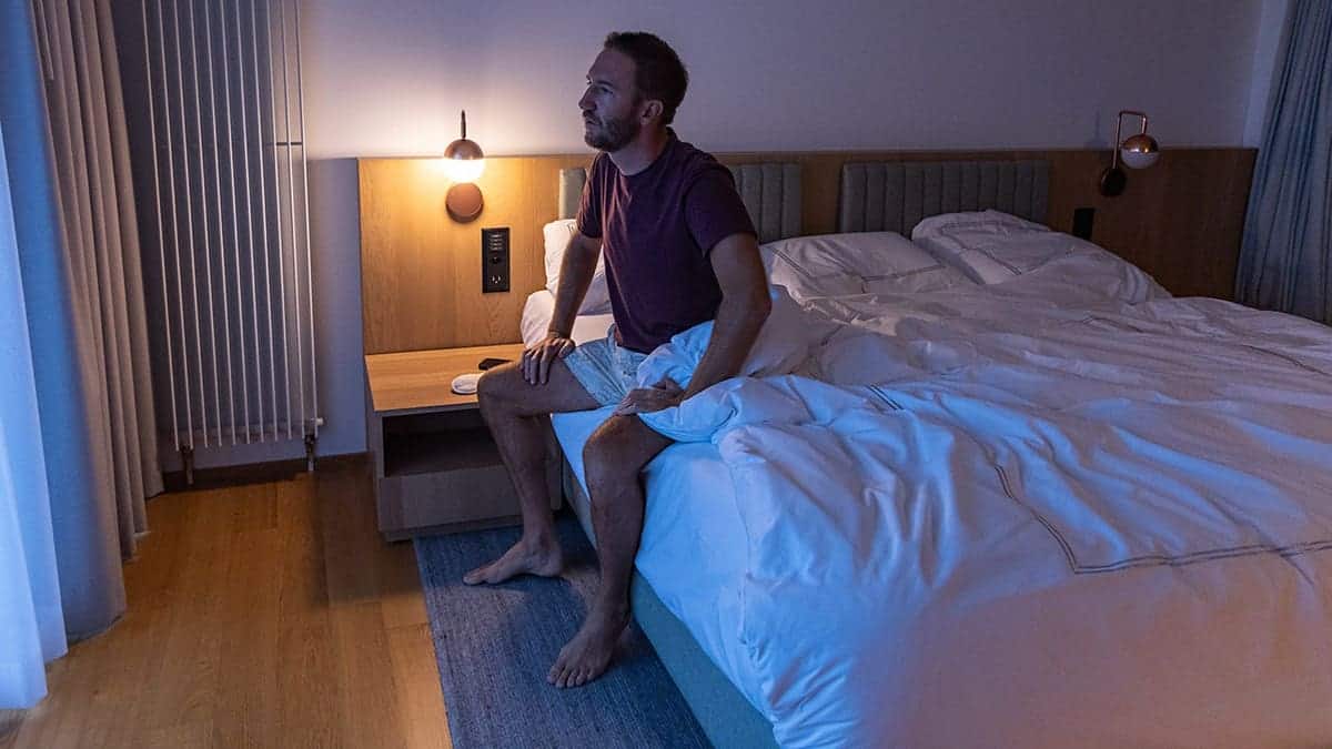 Man waking up in bed.