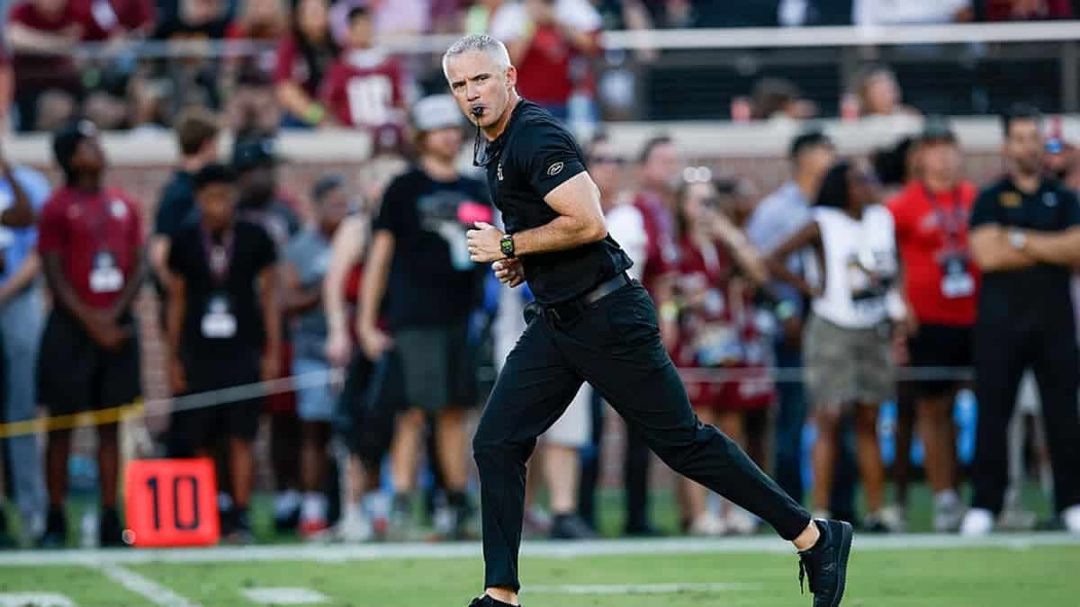 Mike Norvell stands on the field before a game at Doak S. Campbell Stadium.