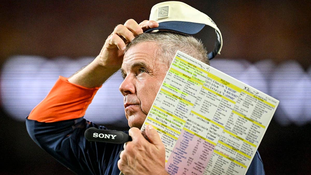Sean Payton scratches his head on the sideline during a game at Arrowhead Stadium.