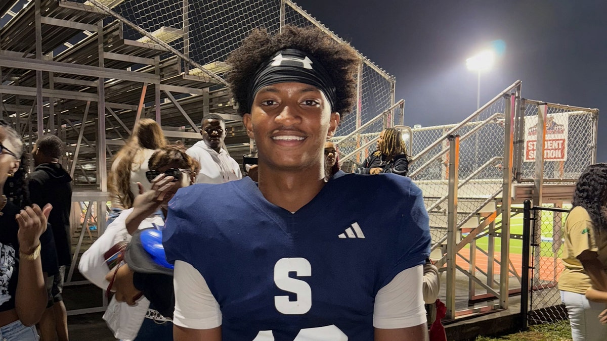 Football player posing in jersey.