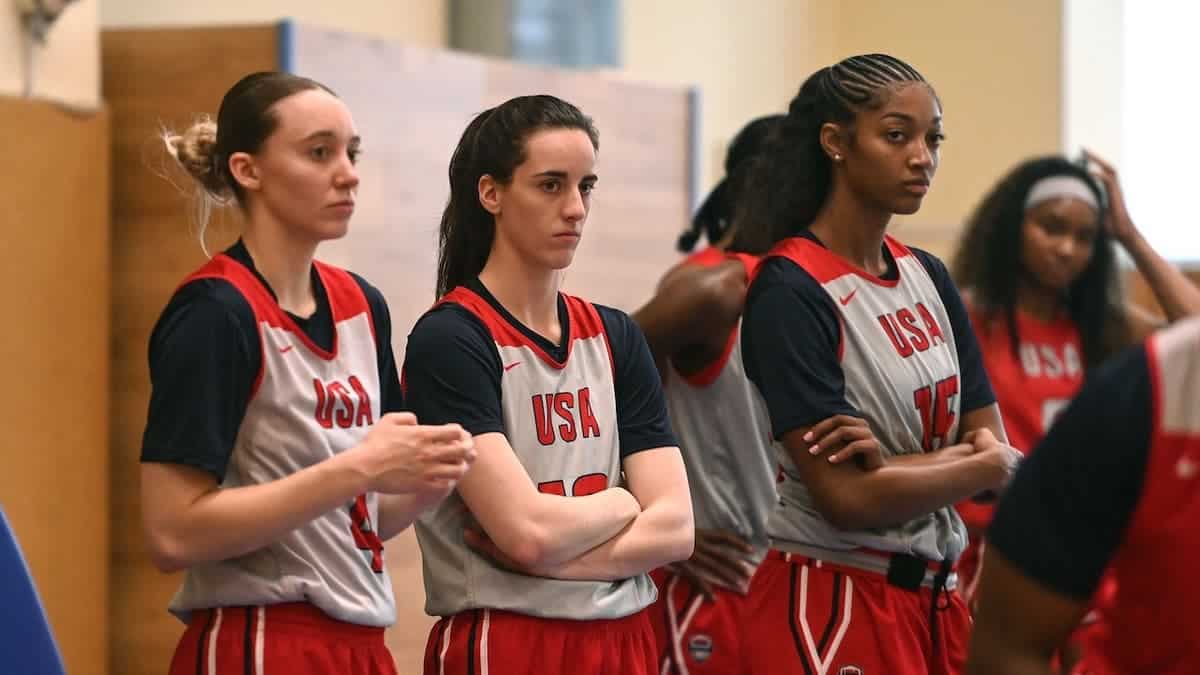 Paige Bueckers, Caitlin Clark and Angel Reese look on during practice.