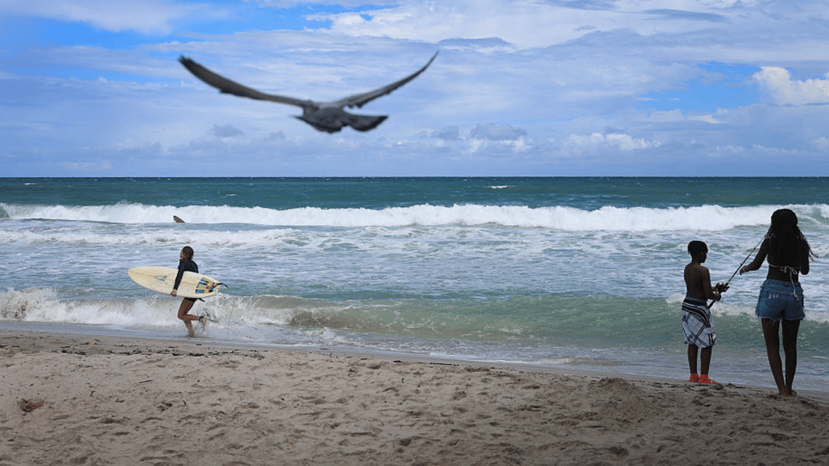 People enjoy Atlantic Ocean waters at Dania Beach, Florida.