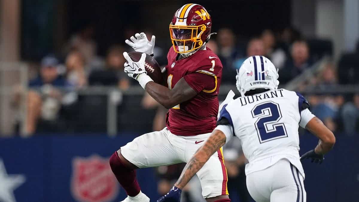 Rachaad White catches the ball against Cobie Durant during an NFL game in Arlington, Texas.