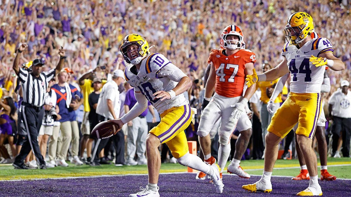 Sam Leavitt celebrates after scoring a touchdown at Tiger Stadium.