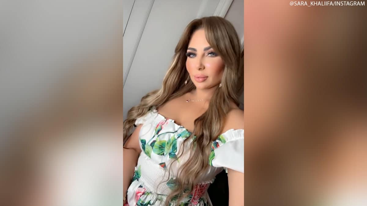Sara Khaliifa taking a selfie video while wearing a white floral outfit