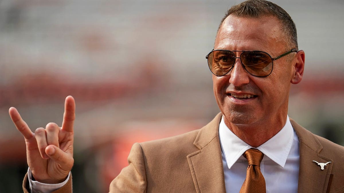 Steve Sarkisian walks across the field at Darrell K Royal-Texas Memorial Stadium.