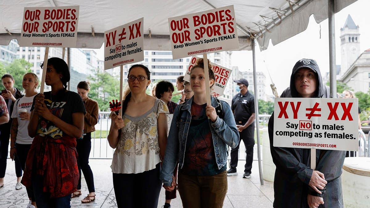Demonstrators listening to speakers at a Title IX rally at Freedom Plaza in Washington, D.C.
