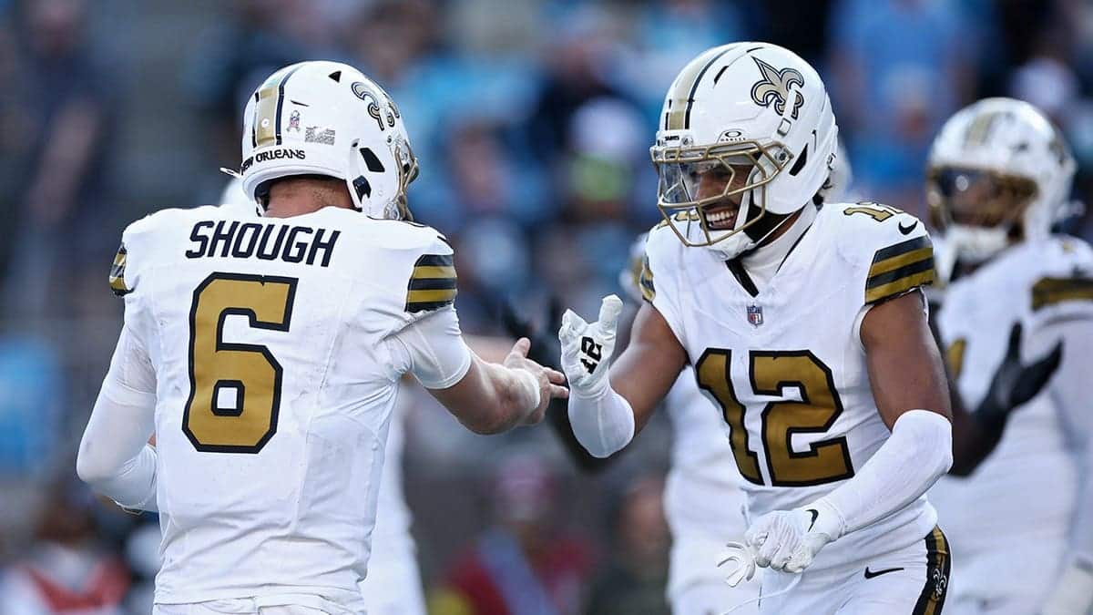 Tyler Shough #6 and Chris Olave #12 of the New Orleans Saints celebrate a touchdown.