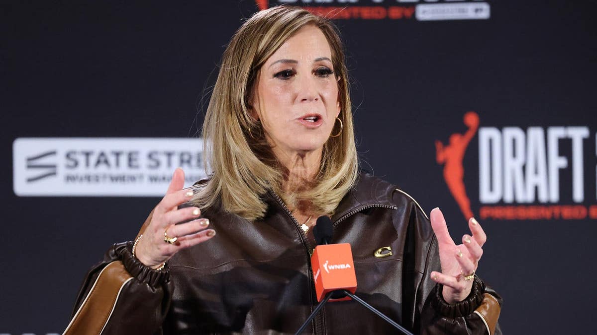 WNBA commissioner Cathy Engelbert speaking at a podium.