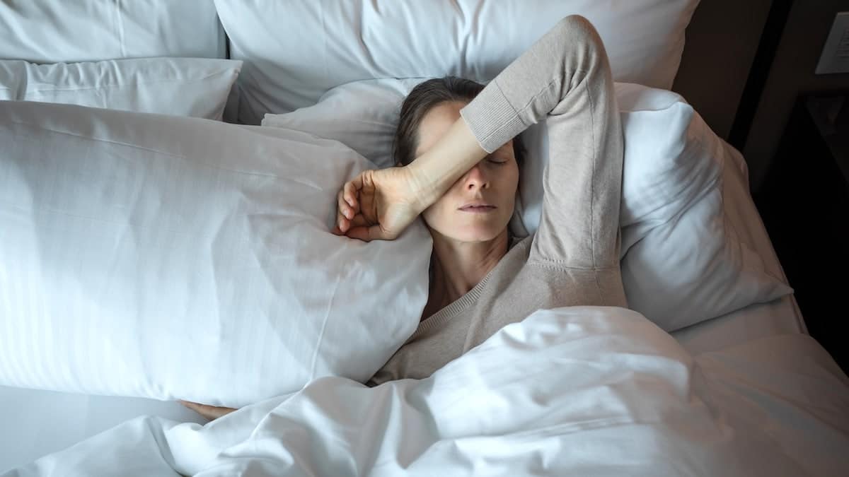 Woman waking up after night of insomnia