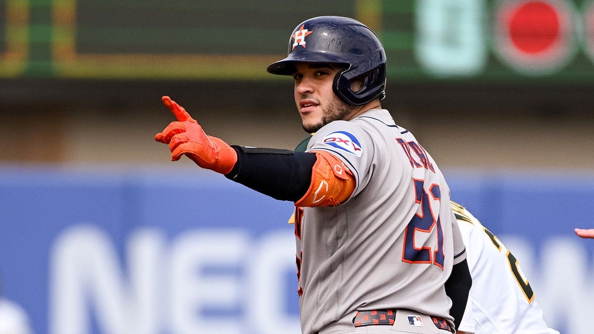 Yainer Diaz motions to teammates after hitting a double against the Athletics.