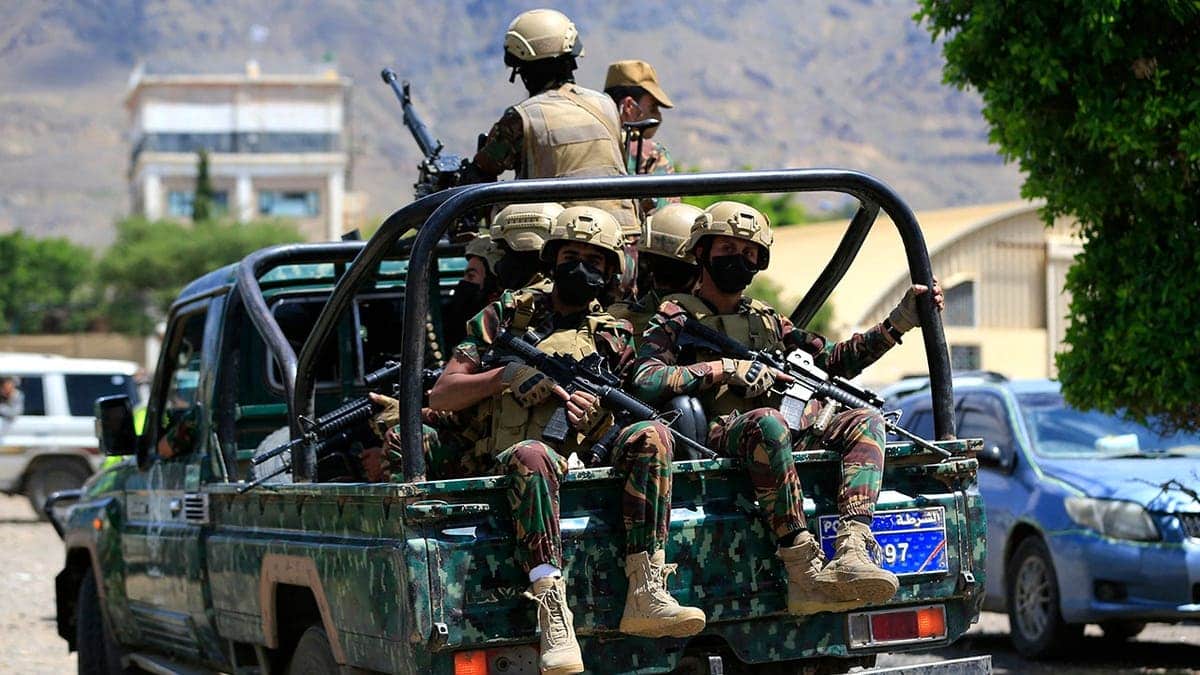 Houthi armed forces patrol as Yemeni prisoners loyal to Houthi authorities arrive in Sanaa