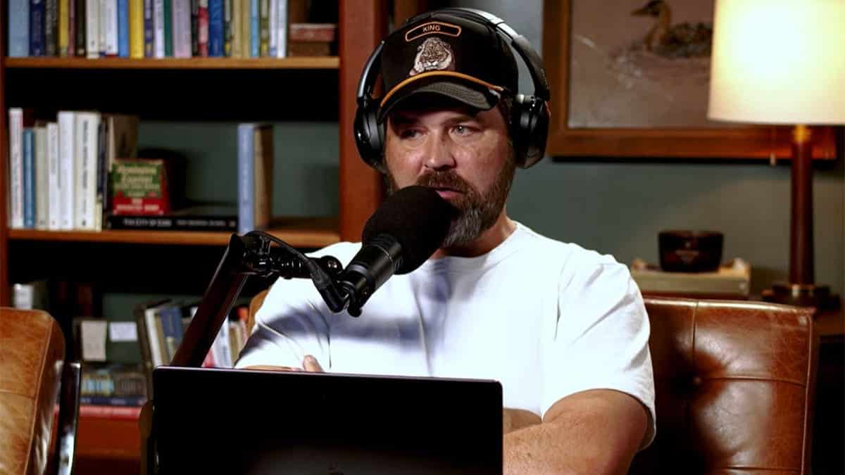 Zach Dasher speaking into the microphone during an episode of his podcast,