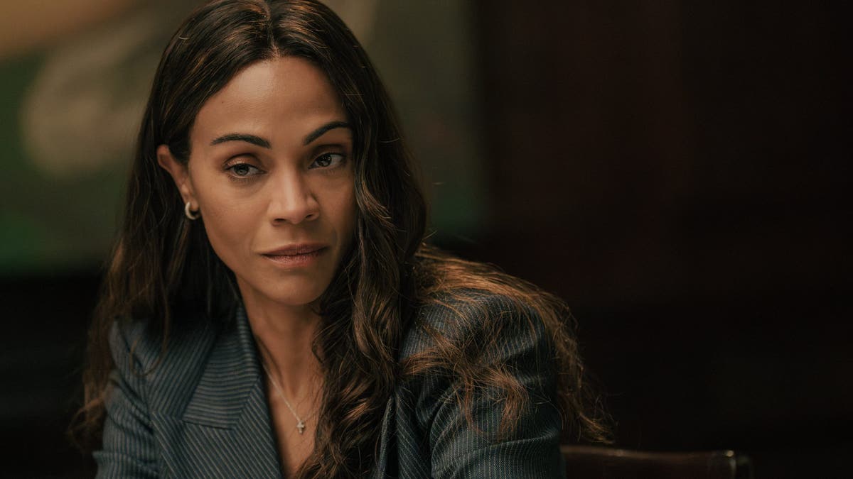 Zoe Saldaña stands as Joe in Lioness.