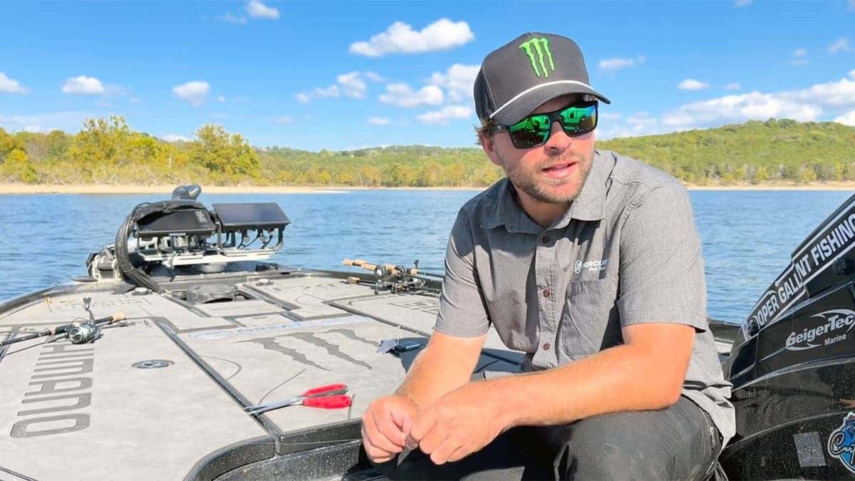 Cooper Gallant sits in fishing boat on lake