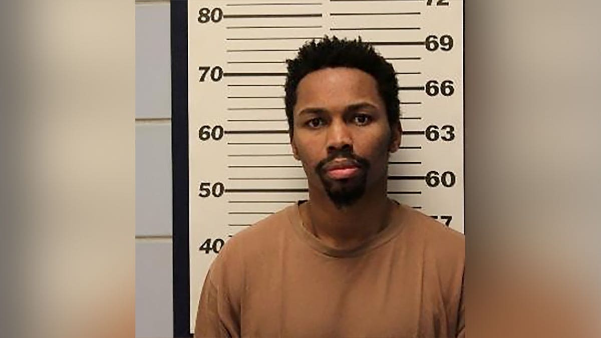 Mugshot of shooting suspect Jerrell Jackson standing in front of a height chart