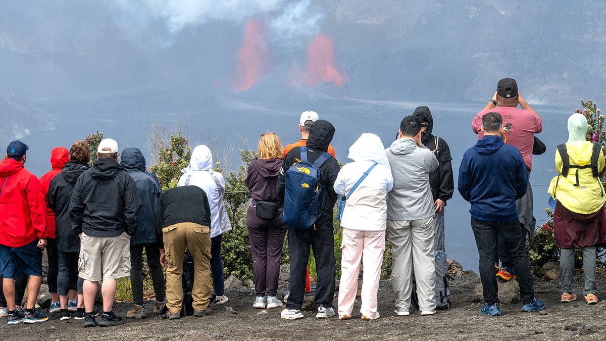Visitors witnessing lava outside Hawaii Volcanos National Park