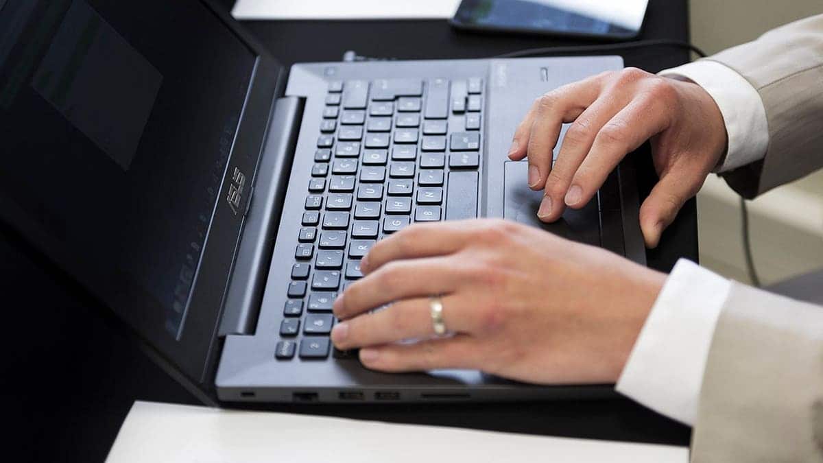 Man typing on his computer.